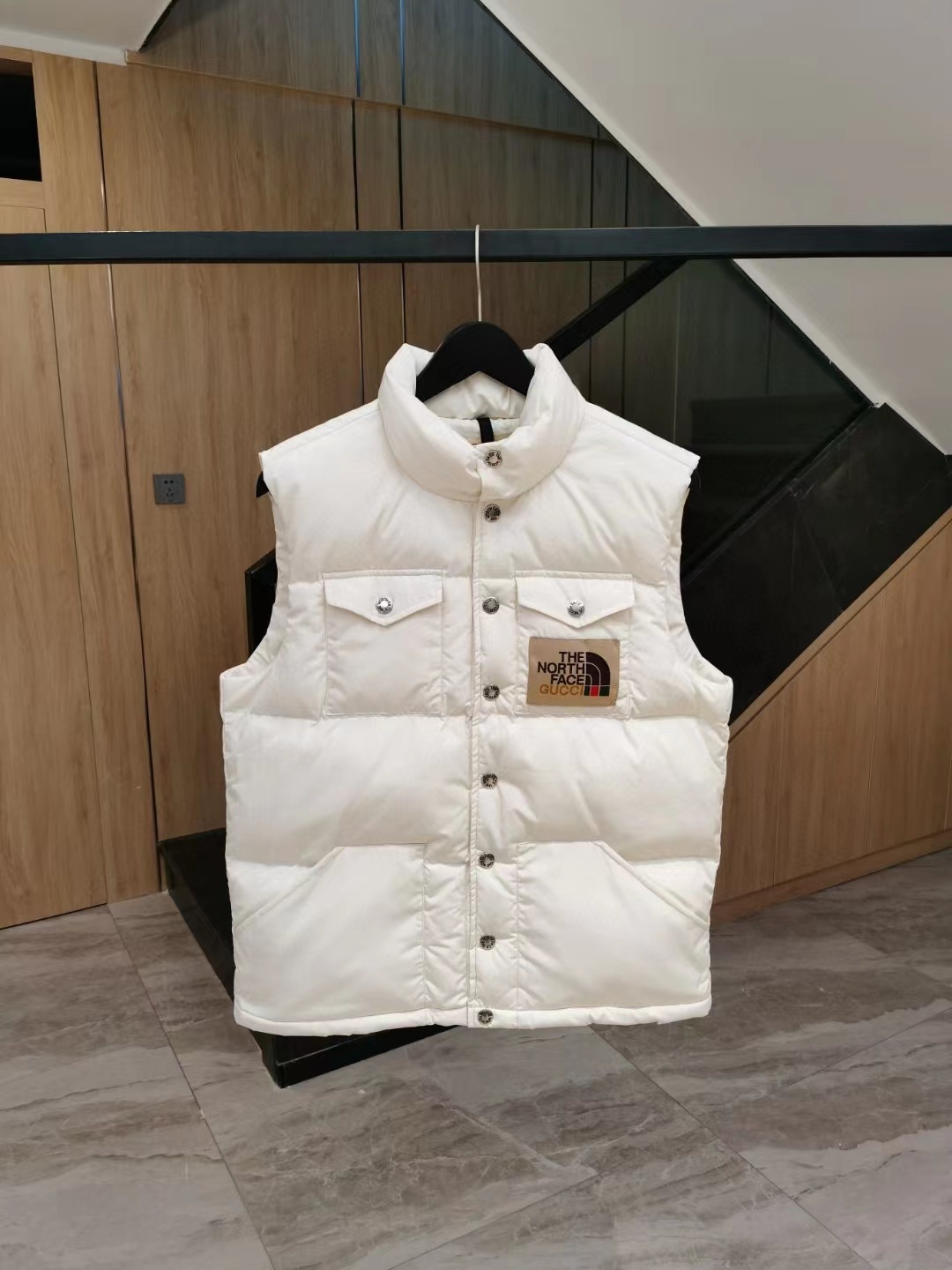 The North Face white puffer vest with logo patch
