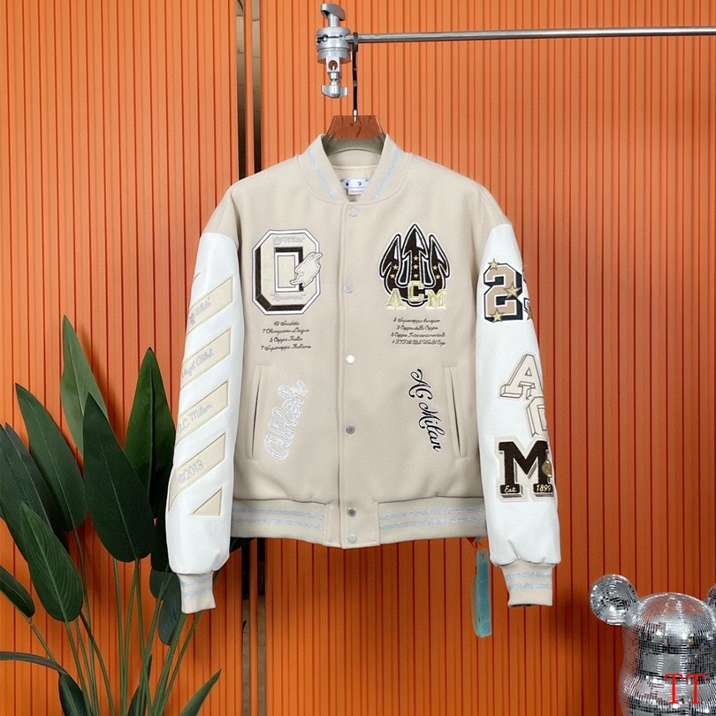 Beige and white varsity jacket with embroidered logos and cartoon graphic